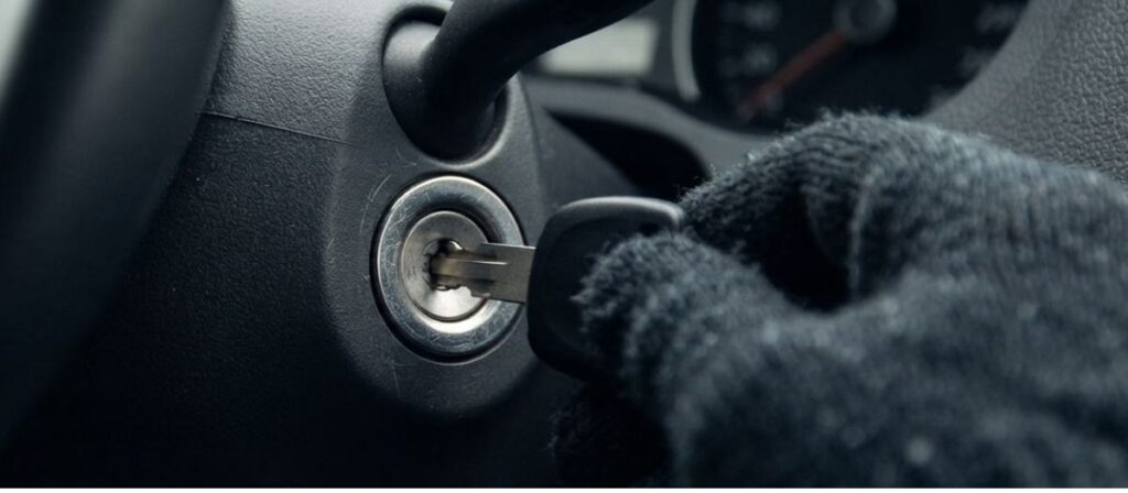 Driver testing a spare car key in the ignition to diagnose ignition repair vs replacement
